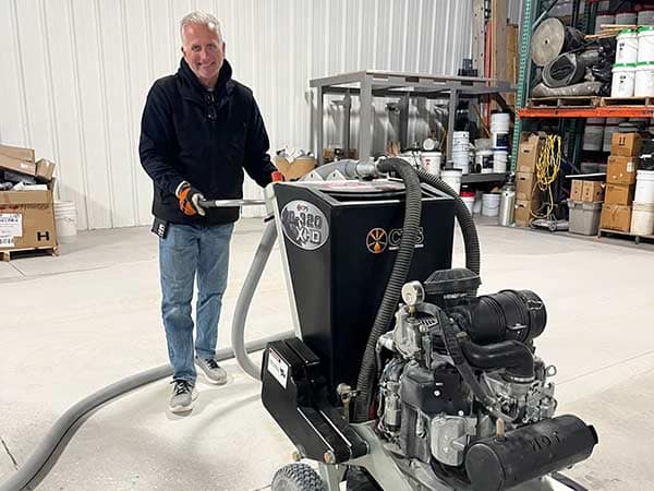A man operating a concrete floor grinder.