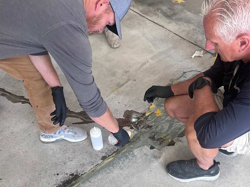 Applying mender to a cracked concrete floor