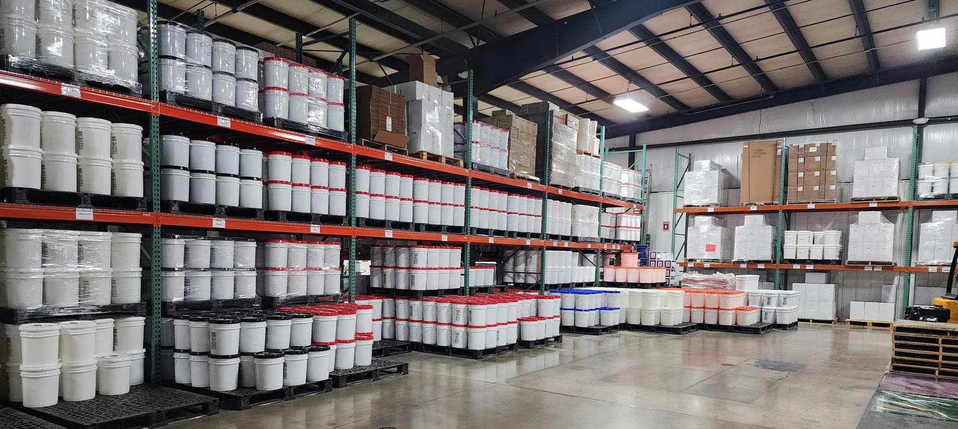 Warehouse full of concrete floor coating products.